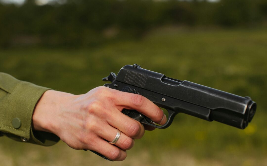 a mans hand holding a gun